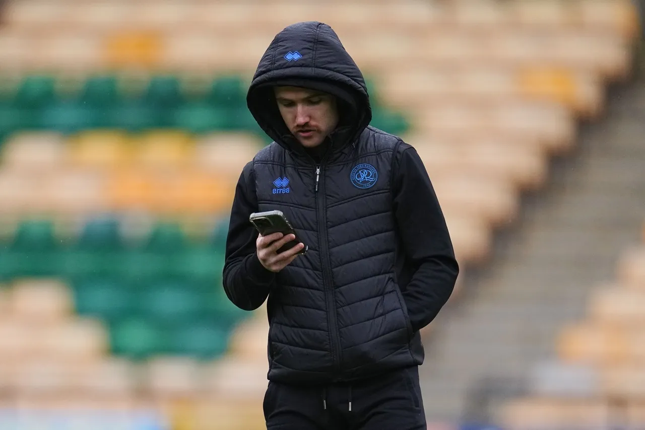 QPR players on his phone before training session at the Championship club