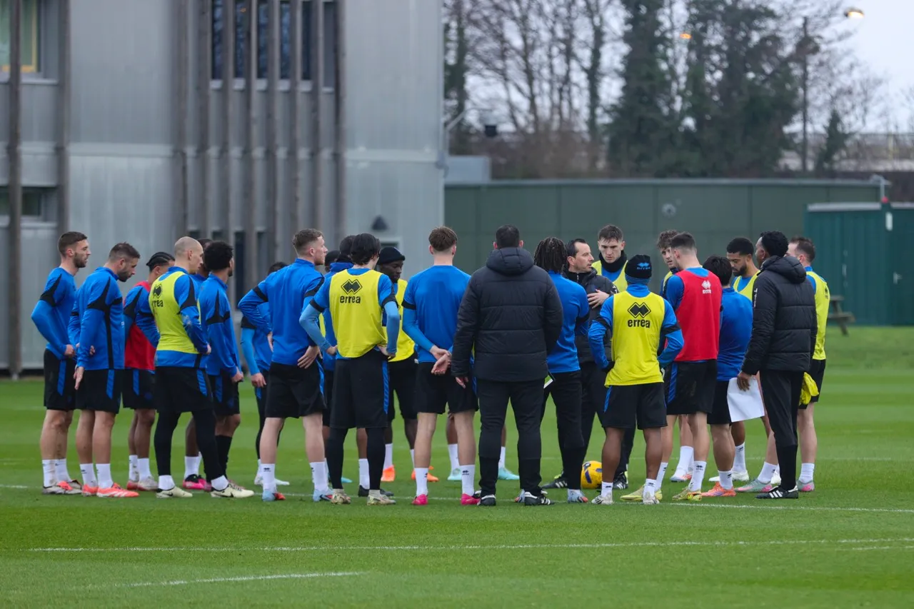 QPR squad in pre-match huddle during training